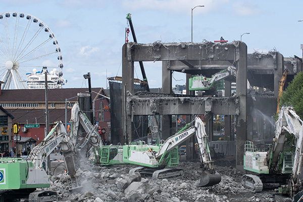 Heavy machinery dissassembles the concrete Alaskan Way Viaduct in Seattle